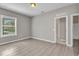A spacious bedroom features neutral walls, tile floors, a window, and doorways leading to other parts of the house at 2640 Suncoast Lakes Blvd, Punta Gorda, FL 33980