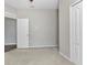 Neutral-colored bedroom with carpet flooring, two white doors, and neutral-colored walls at 2640 Suncoast Lakes Blvd, Punta Gorda, FL 33980