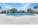 Large community pool featuring a covered lounge area, ample seating, and beautiful landscaping at 2640 Suncoast Lakes Blvd, Punta Gorda, FL 33980