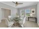 Elegant dining room with a glass-top table, white chairs, and bright windows offering scenic views at 2640 Suncoast Lakes Blvd, Punta Gorda, FL 33980