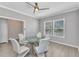 Bright dining room featuring a modern glass table, stylish chairs, tile flooring, and a contemporary ceiling fan at 2640 Suncoast Lakes Blvd, Punta Gorda, FL 33980