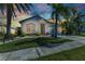Charming single-story home with a well-manicured lawn, mature palms, and a spacious driveway at 2640 Suncoast Lakes Blvd, Punta Gorda, FL 33980