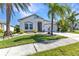 Beautiful single-story home with tropical landscaping, a driveway, and a two-car garage at 2640 Suncoast Lakes Blvd, Punta Gorda, FL 33980