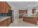 Spacious kitchen with custom wood cabinets, granite countertops, stainless steel appliances, and tile flooring at 2640 Suncoast Lakes Blvd, Punta Gorda, FL 33980