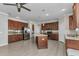 Spacious kitchen featuring wooden cabinets, stainless steel appliances, granite countertops, and an island at 2640 Suncoast Lakes Blvd, Punta Gorda, FL 33980