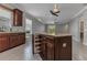 Kitchen island with granite countertops, storage, and seating area at 2640 Suncoast Lakes Blvd, Punta Gorda, FL 33980