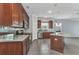 Open kitchen with rich wood cabinets, stainless steel appliances, and a spacious island at 2640 Suncoast Lakes Blvd, Punta Gorda, FL 33980