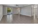 Spacious living room featuring tiled floors and sliding glass doors to the lanai and pool at 2640 Suncoast Lakes Blvd, Punta Gorda, FL 33980