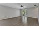 Open-concept living room with tile flooring and sliding glass doors to the patio at 2640 Suncoast Lakes Blvd, Punta Gorda, FL 33980