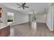 Open living room featuring wood-look tile flooring, ample space and sliders leading to screened in pool area at 2640 Suncoast Lakes Blvd, Punta Gorda, FL 33980