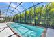 Inviting screened-in pool perfect for relaxation and entertaining, surrounded by lush greenery for privacy at 2640 Suncoast Lakes Blvd, Punta Gorda, FL 33980