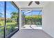 A screened porch with a view of the backyard pool and lush landscaping, offering a serene outdoor living space at 2640 Suncoast Lakes Blvd, Punta Gorda, FL 33980