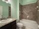 Bathroom featuring a tiled tub shower combo, and granite-topped vanity at 675 Hartford Heights St, Spring Hill, FL 34609