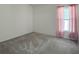 A serene bedroom featuring neutral carpet, a bright window with pink curtains, and ample natural light at 675 Hartford Heights St, Spring Hill, FL 34609