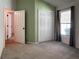 This bedroom features neutral carpet, a double closet, and a sunny window for a comfortable and inviting space at 675 Hartford Heights St, Spring Hill, FL 34609