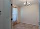Bright, empty room with tile floors, natural light, and a decorative chandelier at 675 Hartford Heights St, Spring Hill, FL 34609