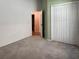Cozy bedroom featuring neutral walls and carpet, with a door to the ensuite and a closet, bathed in natural light at 675 Hartford Heights St, Spring Hill, FL 34609