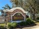 Stone sign that reads: Bristol Place, surrounded by lush landscaping and mature trees at 675 Hartford Heights St, Spring Hill, FL 34609