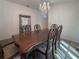 Dining room features a chandelier and formal wood table with seating for six at 675 Hartford Heights St, Spring Hill, FL 34609
