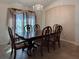 Elegant dining room with traditional furniture set and chandelier; bright, welcoming space at 675 Hartford Heights St, Spring Hill, FL 34609