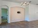 Bright dining room featuring tile flooring, elegant chandelier, and arched doorway at 675 Hartford Heights St, Spring Hill, FL 34609