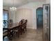 Elegant dining room featuring a chandelier, tile floors, and an archway leading to another room at 675 Hartford Heights St, Spring Hill, FL 34609