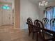 Elegant dining room with tile floors, chair railing, and plenty of natural light at 675 Hartford Heights St, Spring Hill, FL 34609