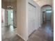 Hallway featuring tile flooring, closet, and view into living spaces at 675 Hartford Heights St, Spring Hill, FL 34609
