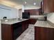 Kitchen features granite countertops, stainless steel sink, and dark wood cabinetry at 675 Hartford Heights St, Spring Hill, FL 34609