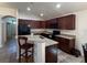 Well-equipped kitchen features granite counters, stainless steel sink, and dark wood cabinetry at 675 Hartford Heights St, Spring Hill, FL 34609