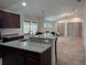 Open-concept kitchen featuring granite countertops and an island with bar seating at 675 Hartford Heights St, Spring Hill, FL 34609
