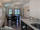 Open-concept living and dining area with tile floors and modern chandeliers at 675 Hartford Heights St, Spring Hill, FL 34609