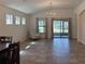 Bright and airy living room with tile flooring, vaulted ceiling, and large sliding glass doors at 675 Hartford Heights St, Spring Hill, FL 34609