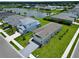 Stunning aerial view of homes with lush lawns and a serene lake, showcasing neighborhood charm at 14552 Skipping Stone Loop, Parrish, FL 34219