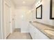 Bright bathroom features a double vanity, granite countertops, and a tiled walk-in shower at 14552 Skipping Stone Loop, Parrish, FL 34219