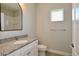 Clean and modern bathroom featuring a vanity with granite countertop, a square mirror, and a walk-in shower at 14552 Skipping Stone Loop, Parrish, FL 34219