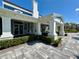 Exterior entryway featuring large white columns, decorative stonework, and seating area at 14552 Skipping Stone Loop, Parrish, FL 34219