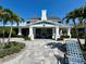 Clubhouse exterior with a large chimney, covered porch, and outdoor seating area at 14552 Skipping Stone Loop, Parrish, FL 34219