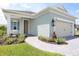 Welcoming home exterior featuring a stone-paved walkway leading to the front entrance, a two-car garage, and lush landscaping at 14552 Skipping Stone Loop, Parrish, FL 34219