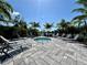 Outdoor hot tub surrounded by seating and palm trees on a sunny day at 14552 Skipping Stone Loop, Parrish, FL 34219