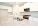 Bright kitchen with white cabinetry, granite countertops, stainless steel appliances, and a stylish tile backsplash at 14552 Skipping Stone Loop, Parrish, FL 34219