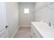 Bright laundry room features a utility sink, ample cabinet space, and a convenient wire shelving unit at 14552 Skipping Stone Loop, Parrish, FL 34219