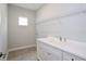 Bright laundry room features a utility sink, ample cabinet space, and a convenient wire shelving unit at 14552 Skipping Stone Loop, Parrish, FL 34219