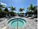 Relaxing community spa features comfortable lounge chairs and tropical palm tree landscaping with a tranquil water view at 14552 Skipping Stone Loop, Parrish, FL 34219