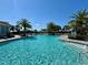 Large community pool with ample seating, palm trees, and clear blue water at 14552 Skipping Stone Loop, Parrish, FL 34219