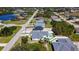 Aerial view of a neighborhood with manicured lawns and ponds at 159 Antilla Dr, Rotonda West, FL 33947