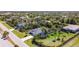 An aerial of a home showcases well-maintained lawns, mature trees, and a serene residential street at 159 Antilla Dr, Rotonda West, FL 33947