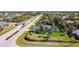 An aerial view of a residential area with lush landscaping, featuring a home with a pool at 159 Antilla Dr, Rotonda West, FL 33947
