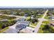 Wide aerial shot showing multiple homes in neighborhood and surrounding wooded areas at 159 Antilla Dr, Rotonda West, FL 33947