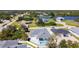 Aerial view of a suburban home with a pool next to a pond and other homes at 159 Antilla Dr, Rotonda West, FL 33947